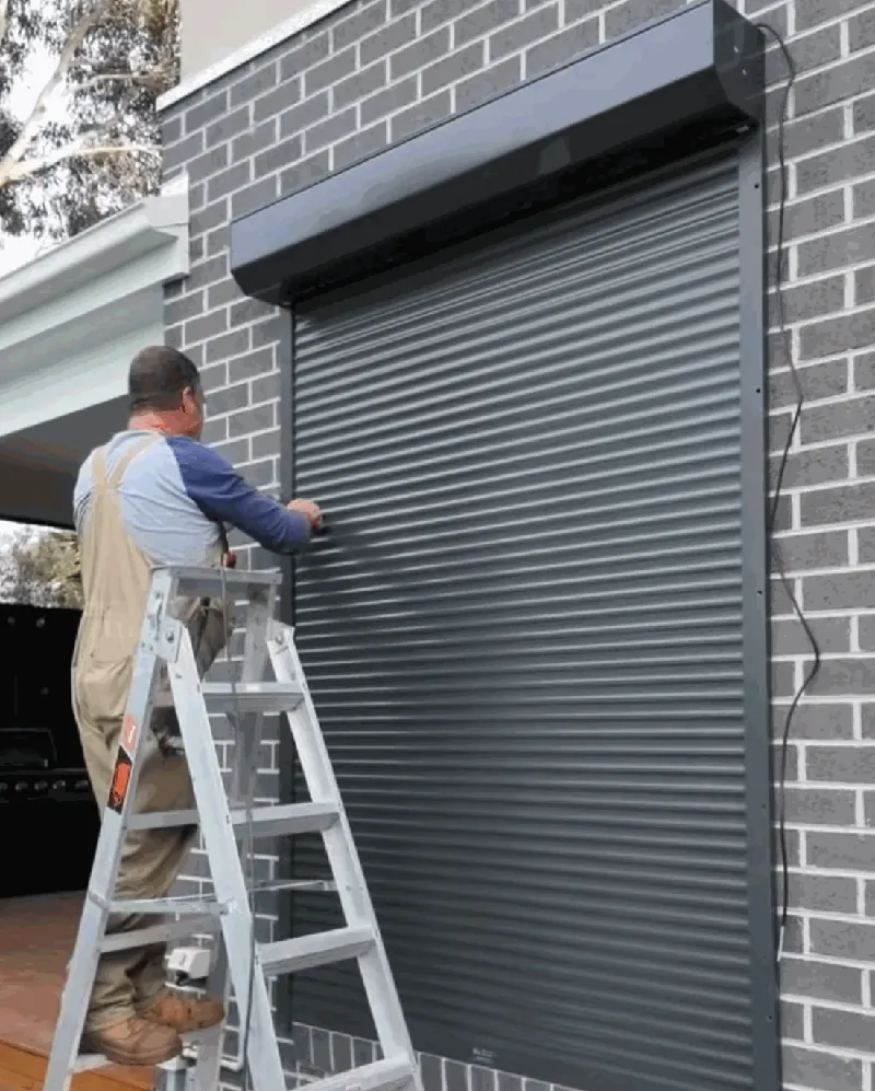 Chris on ladder installing shutters